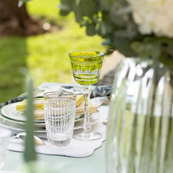 Table setting with clear highball glass Aghata on a table outdoors.