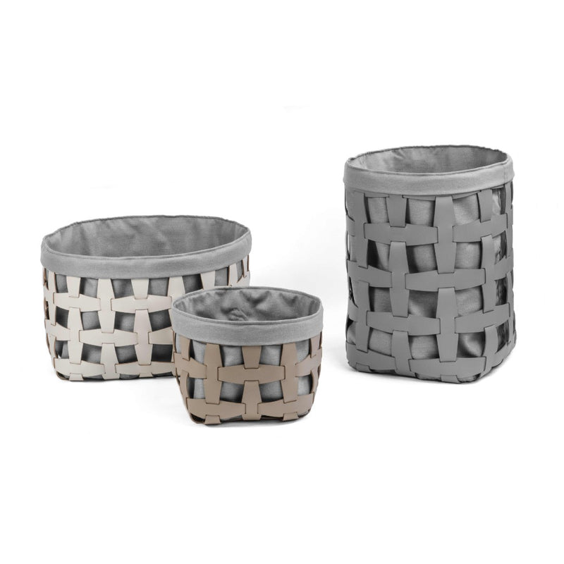 Three woven storage baskets with gray fabric interiors on a white background