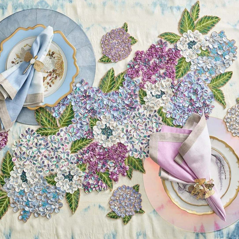 Decorative table setting with floral embellishments and colorful plates.