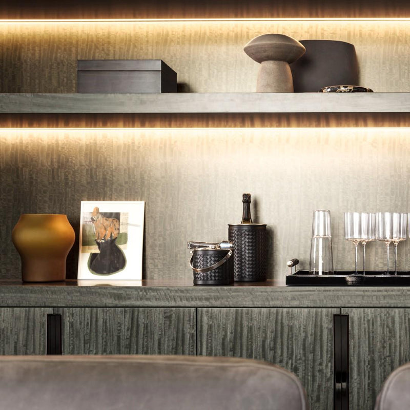 Modern interior with decorative items on a shelf and Luxury handwoven leather ice bucket with lid by Riviere x Giobagnara