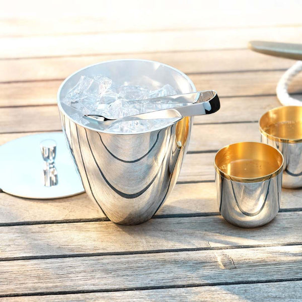 Styled yacht deck with Silver-plated ice bucket with lid filled with ice cubes by Robbe & Berking