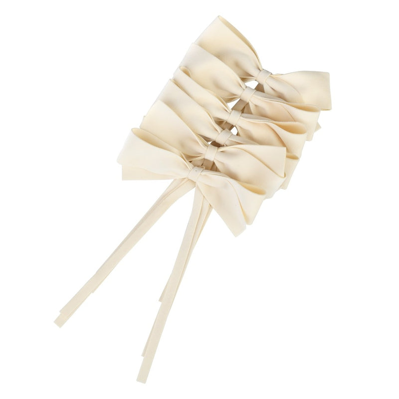 Ivory velvet bows by Roseberry Home used as elegant napkin ties on a red Christmas table setting.