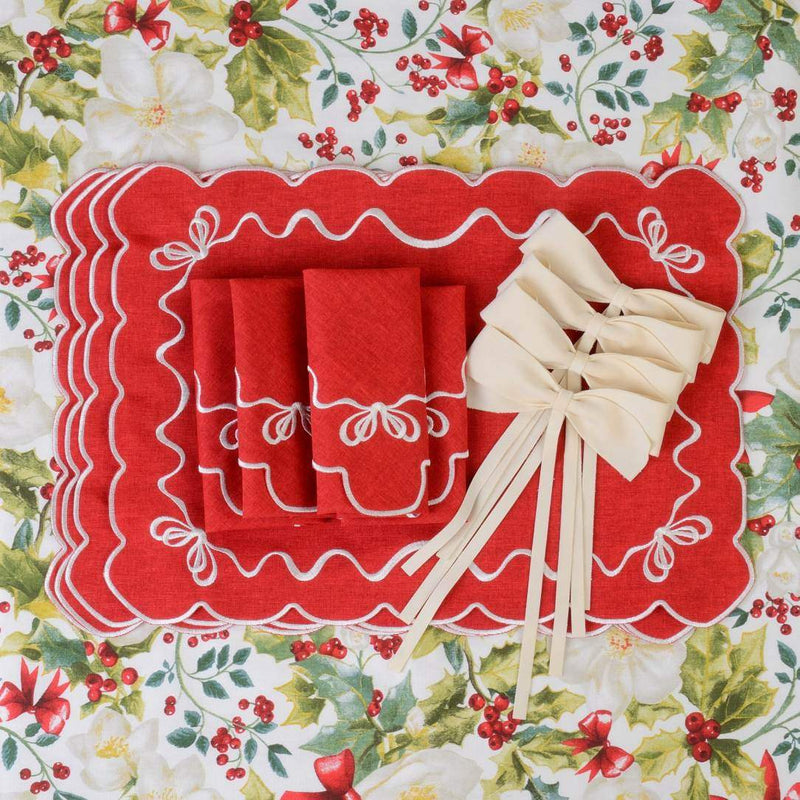 Styled Ivory velvet bows by Roseberry Home used as elegant napkin ties on a red Christmas table setting.