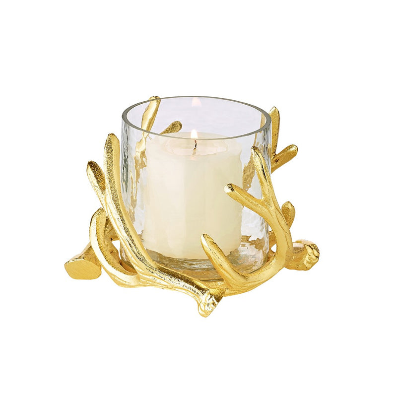 A gold-colored candle holder with deer antlers as a decorative element, featuring a clear glass bowl to hold a candle.
