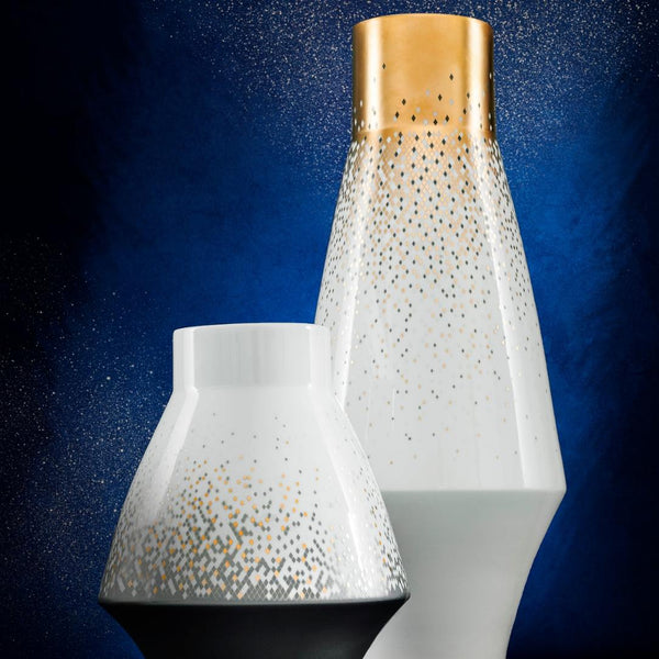 Two decorative vases with gold and white speckled patterns on a blue gradient background