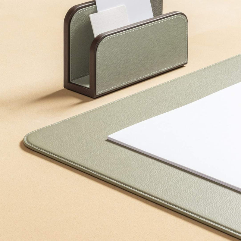 Desk organizer with a pen holder and paper on a beige surface