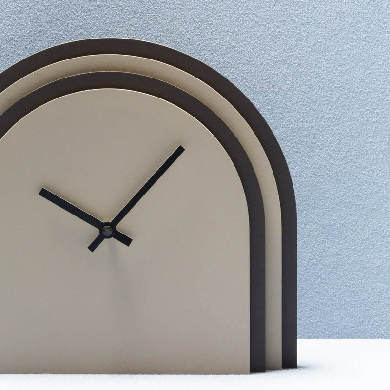 Modern clock with black arch design on a light blue background