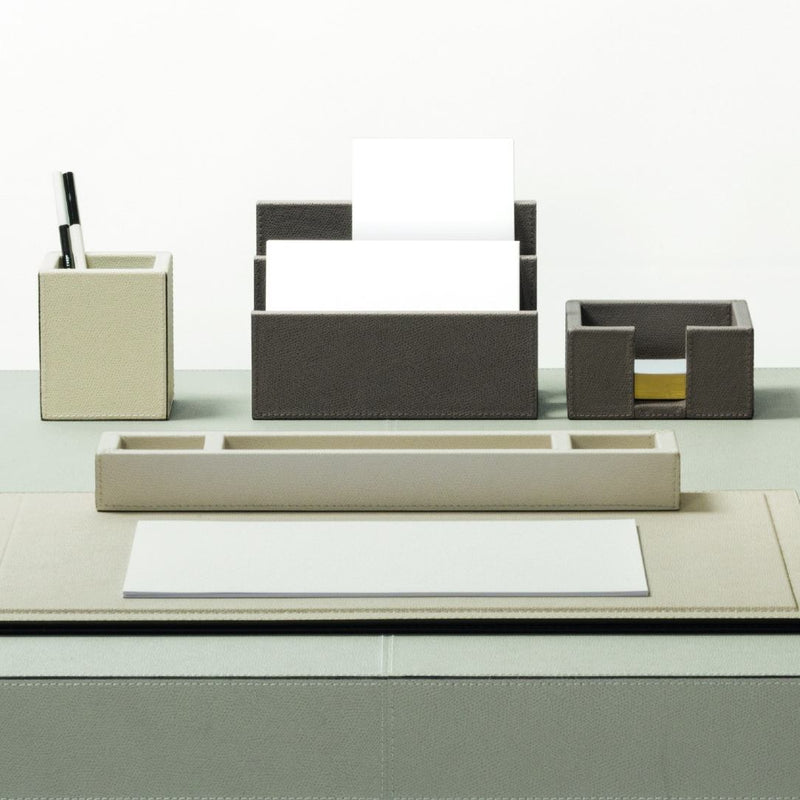 Modern office desk set with various items on a white background