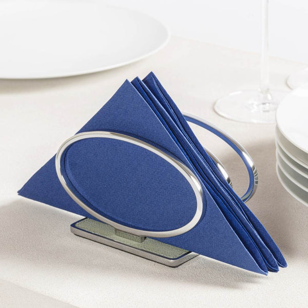 Napkin holder Leather Insert Wire Napkin Holder in chrome finish with calfskin Golf leather base by Giobagnara with blue napkins on a white surface