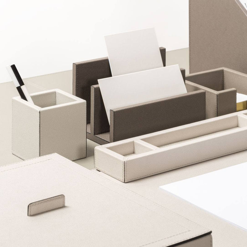 Beige desk organizer with compartments on a white surface