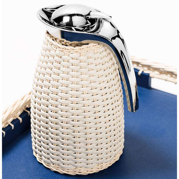 styled Luxury insulated carafe Arles by Pigment France x Giobagnara in stainless steel with woven leather and natural rattan – handcrafted Italian design.
