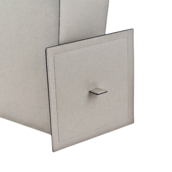 Close-up of a light gray textured Leather Wastepaper Bin Jo by Giobagnara with lid in golf leather