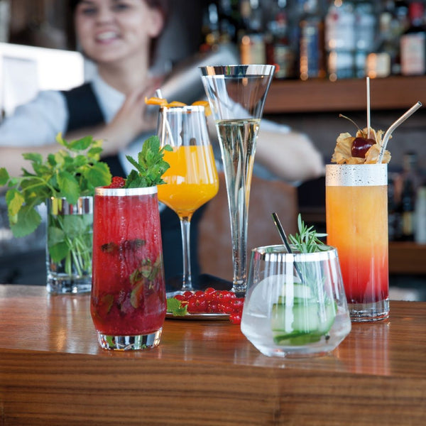 Luxury Longdrink Glass Crystal with Fine Silver Rim – Avantgarde Collection by Sonja Quandt on a bar with a bartender in the background
