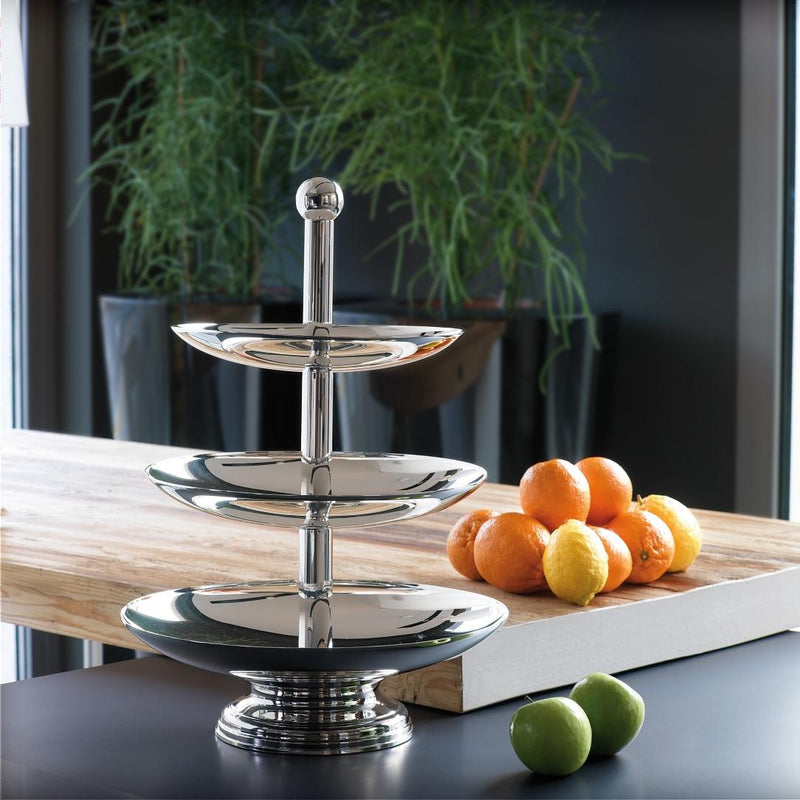 Elegant Luna three-tier silver-plated fruit stand handcrafted in Italy by Schiavon on a table with fruits and a plant in the background