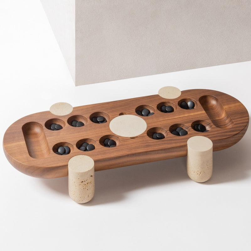 Styled Macambo Wari game set in walnut wood with travertine marble legs and black and white Bakelite beads by Giobagnara