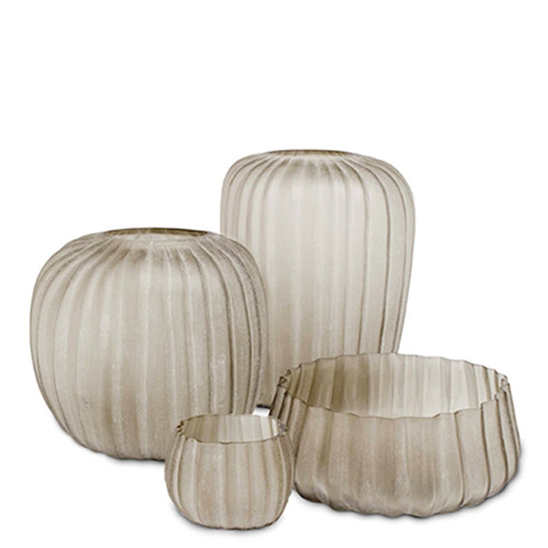 Set of four ribbed glass vases on a white background