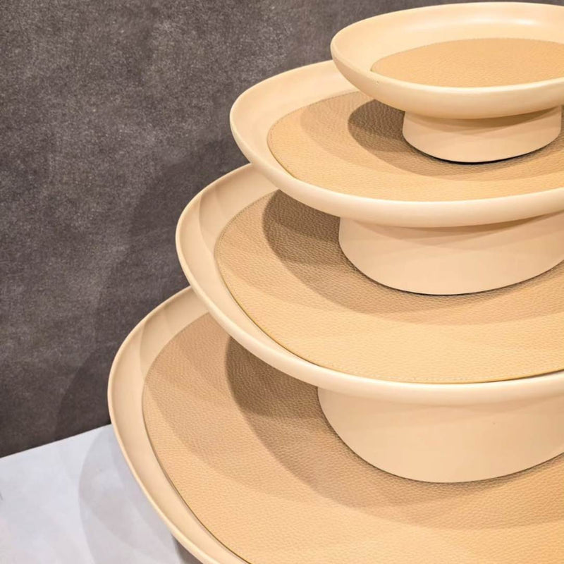 Stack of Maris XLarge cast aluminium raised tray by Kelly Wearstler x Giobagnara, handcrafted in Italy with removable leather inlay on a gray surface