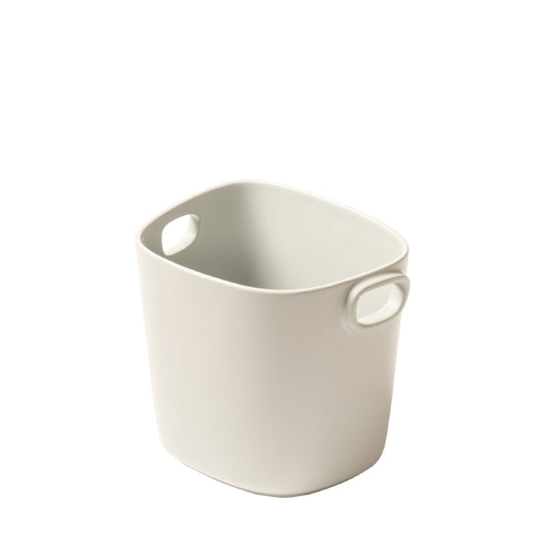 A beige cast aluminium champagne bucket with handles, designed by Kelly Wearstler x Giobagnara.