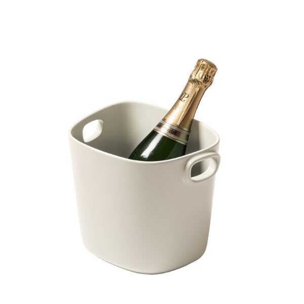 A beige cast aluminium champagne bucket with handles, designed by Kelly Wearstler x Giobagnara.
