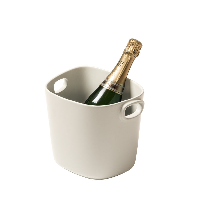 A beige cast aluminium champagne bucket with handles, designed by Kelly Wearstler x Giobagnara.