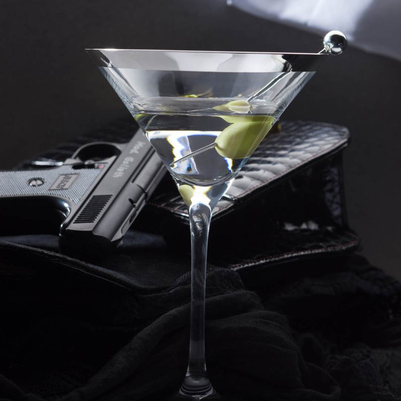 Martini glass with a olive on a dark background