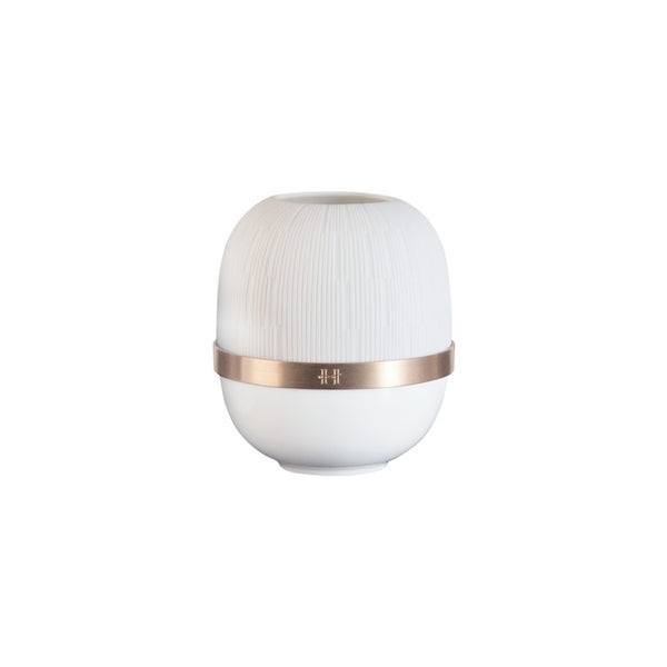 White candle holder with a rose gold band on a white background
