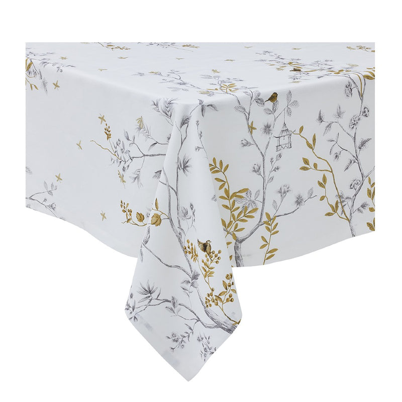 White linen tablecloth with bird and trees embroidery on a white background