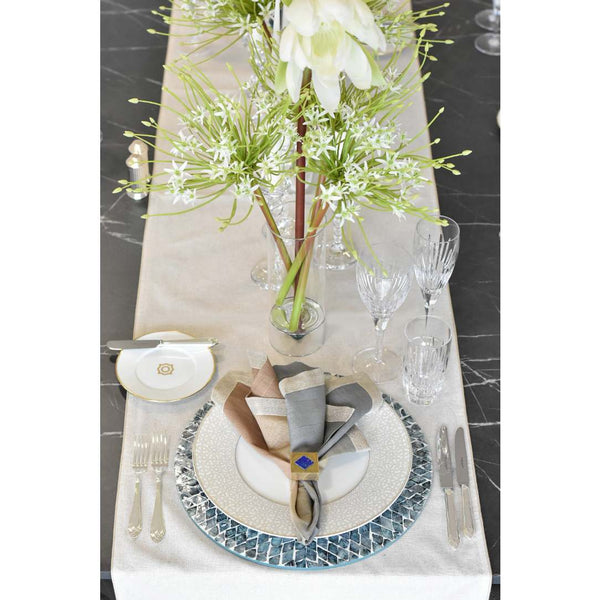 Elegant table setting with floral centerpiece on a marble surface
