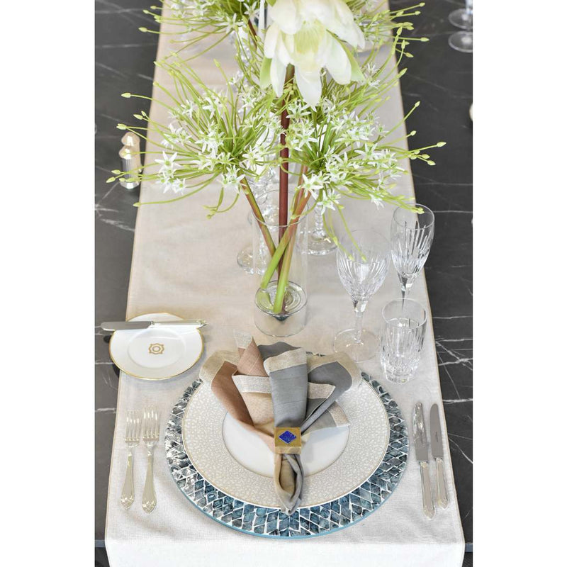 Elegant table setting with floral centerpiece on a marble surface