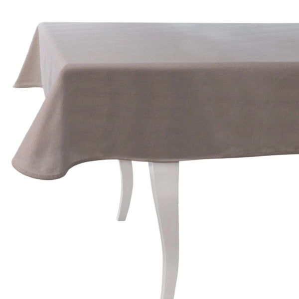 beige tableclothon a table with white legs and white background