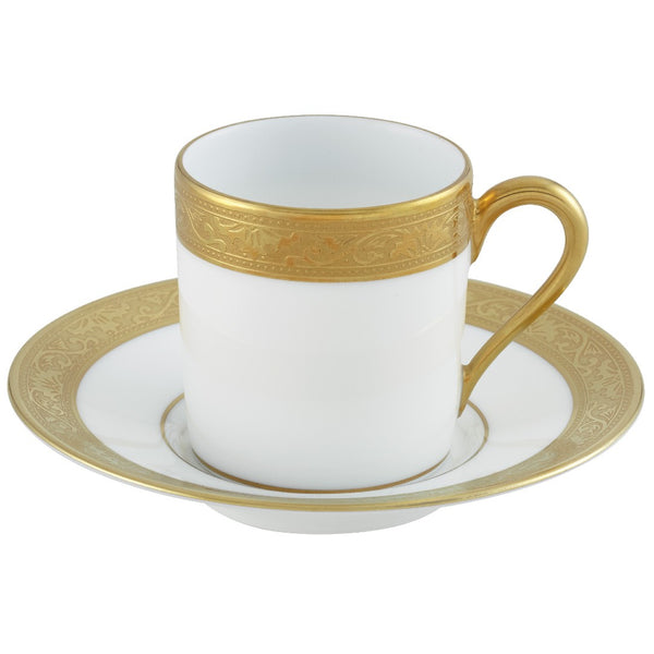 A white and gold porcelain coffee cup and saucer with Renaissance style border inlay.