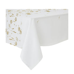 A white linen tablecloth with gold embroidery featuring ear of wheat and country plants, displayed on a table.