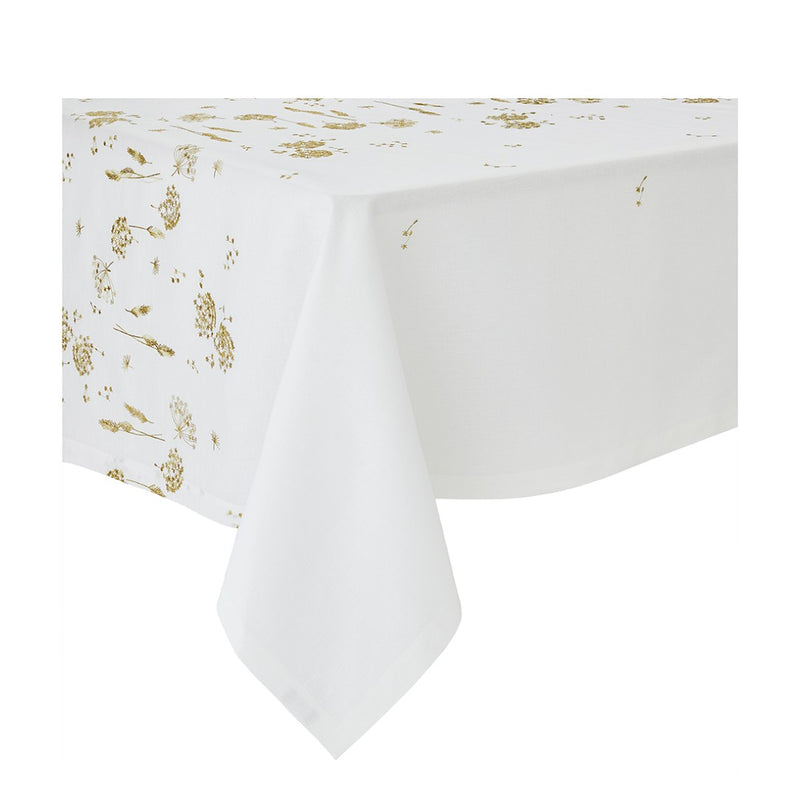 A white linen tablecloth with gold embroidery featuring ear of wheat and country plants, displayed on a table.