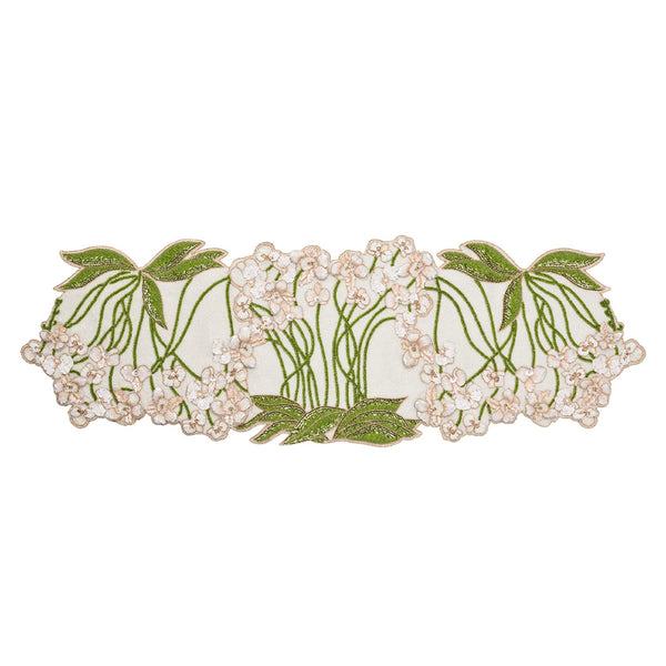 A multicolored beaded table runner with a floral pattern, predominantly in green and white tones.