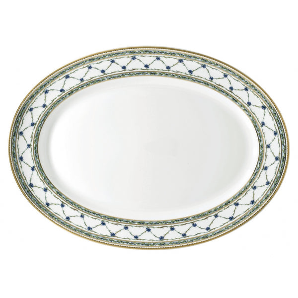 An oval-shaped porcelain platter with a gold and blue floral pattern, featuring a central medallion of cornflowers.