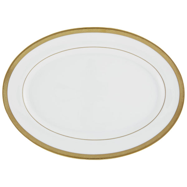 An oval-shaped serving platter with a gold border and inlays, made of white porcelain.