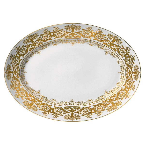 An oval white porcelain platter with gold accents and floral motifs along the rim.