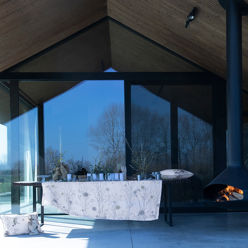 Alexandre Turpault Ovni white linen tablecloth with minimalist geometric border, styled in a modern luxury dining setting