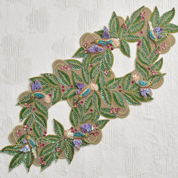 shinny sparkling table runner with beads and crystals in multicolours featuring the bird of paradise on a white background