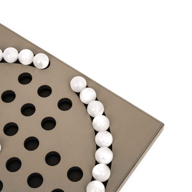 Close-up of the Luxury Peg Solitaire game in taupe grained leather with 33 pearled eco-shell pawns by Pinetti