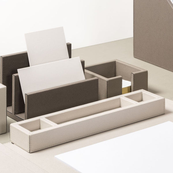 Beige desk organizer with compartments on a white background