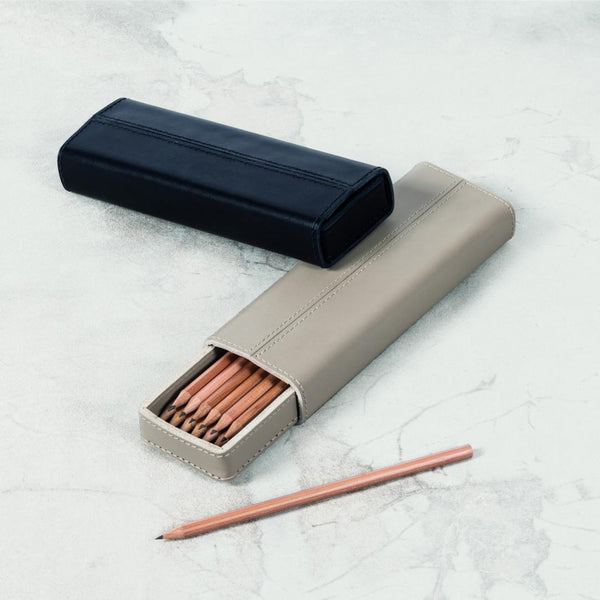 Black and beige pencil case with pencils on a light gray surface