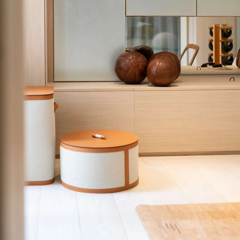 Styled gym with Penelope round storage basket with lid in ecru fabric regenerated leather by Pinetti