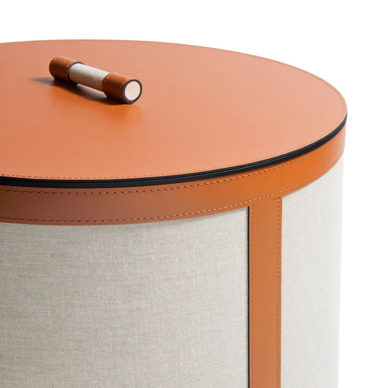 Close-up of Penelope tall round storage basket with lid in ecru fabric and camel regenerated leather by Pinetti
