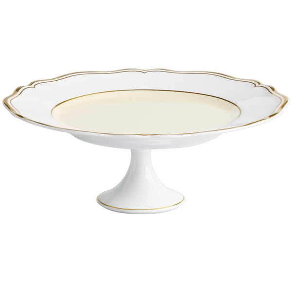 A round, white porcelain cake stand with gold accents on the edges, featuring a scalloped edge and a gold central support.