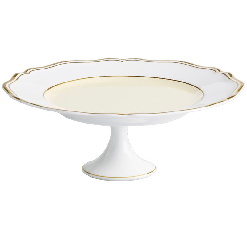 A round, white porcelain cake stand with gold accents on the edges, featuring a scalloped edge and a gold central support.