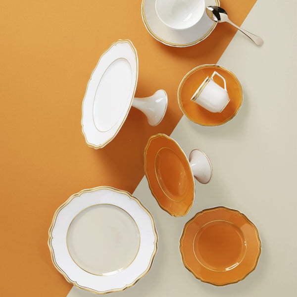 styled Mazurka Ivory petit four & cake stand by Raynaud in Limoges porcelain with golden festoons on an ivory background inspired by the Polka collection.