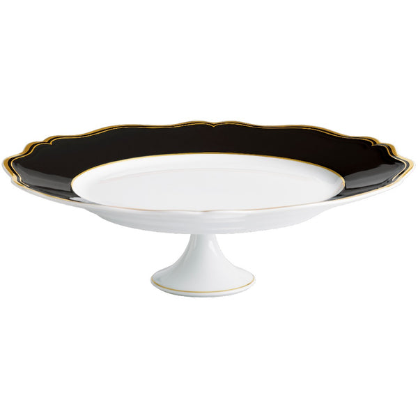 White cake stand with black scalloped edge on a white background