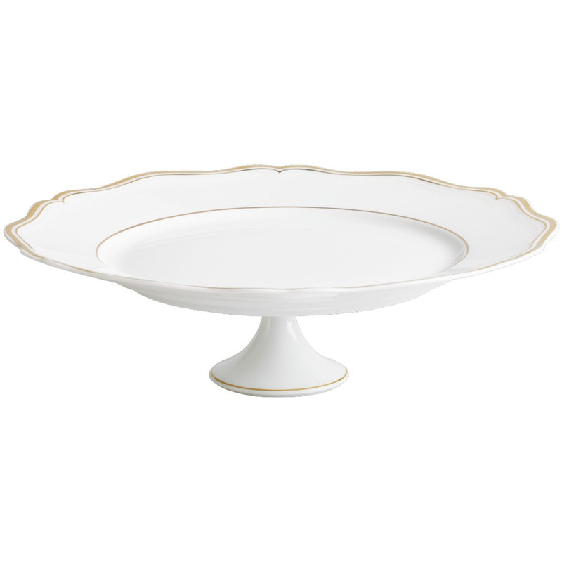 A white porcelain cake stand with gold accents and a scalloped edge.