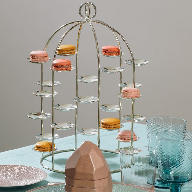 Silver-plated Petit Fours Latitude stand with twenty-four small dishes by Ercuis, designed for displaying macarons on a table with glasses and a box.